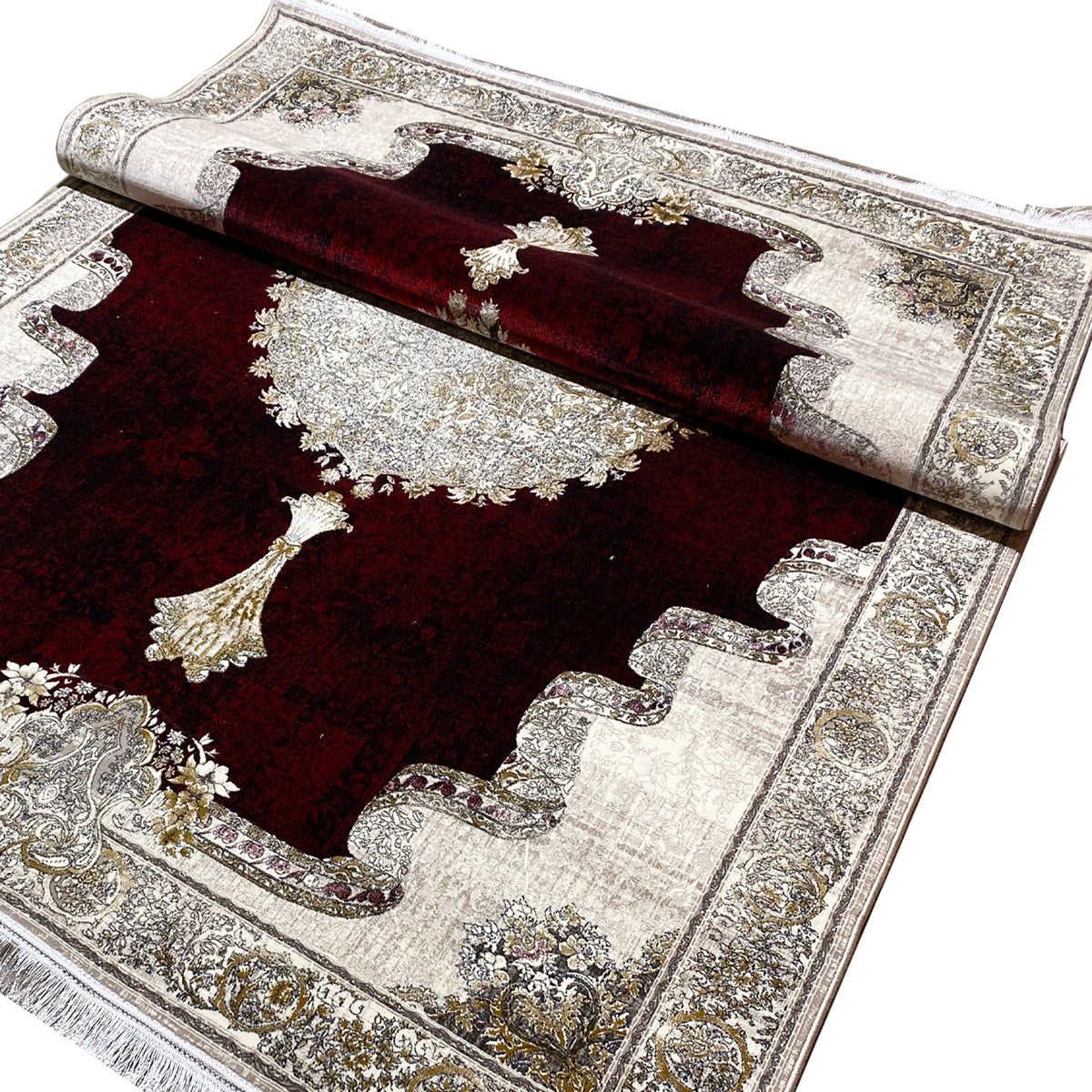 Burgundy-red carpet with a medallion pattern and lavish silver embellishments, close-up