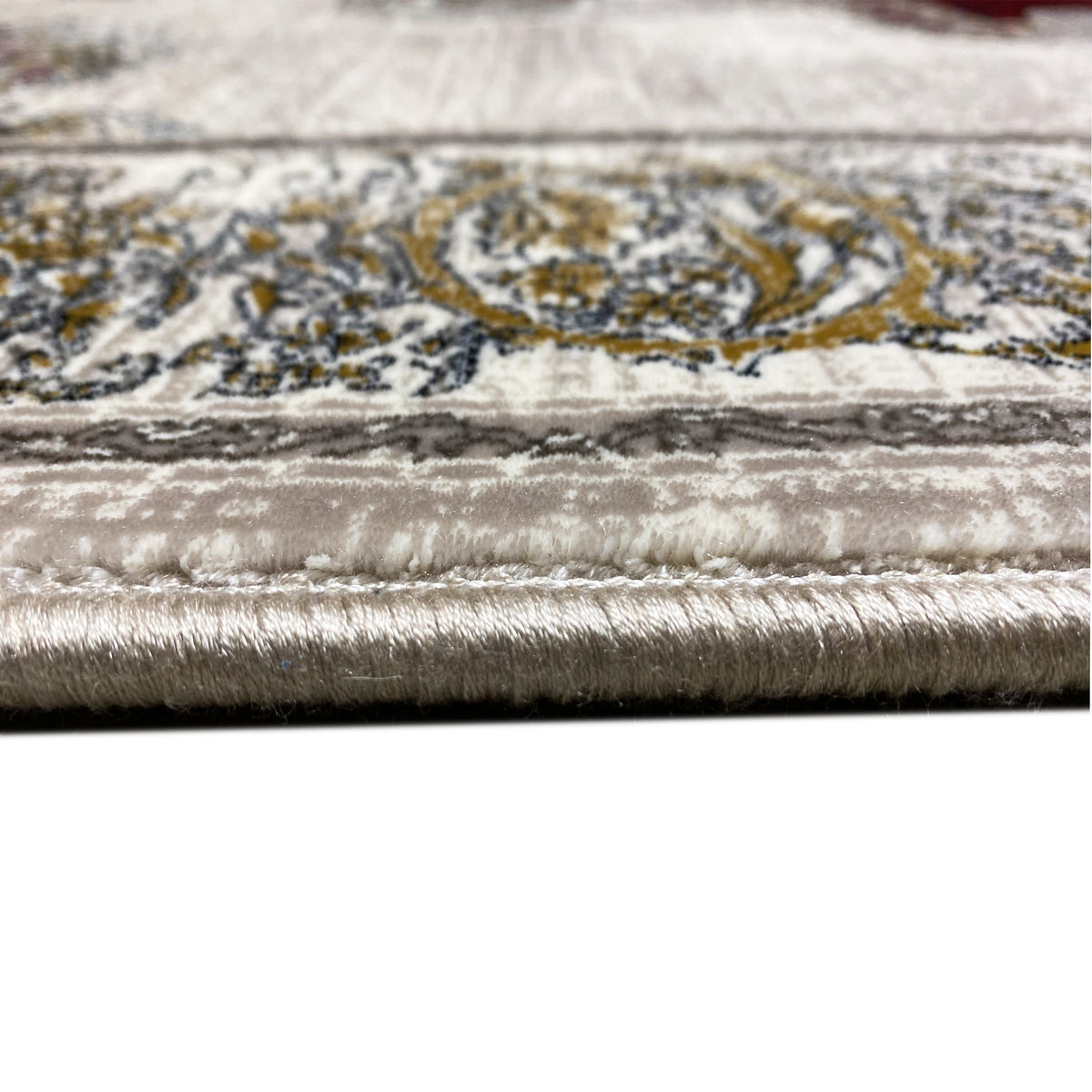 Rug 170x240 cm, border detail: silver pile with gold ornaments and fringed edge.