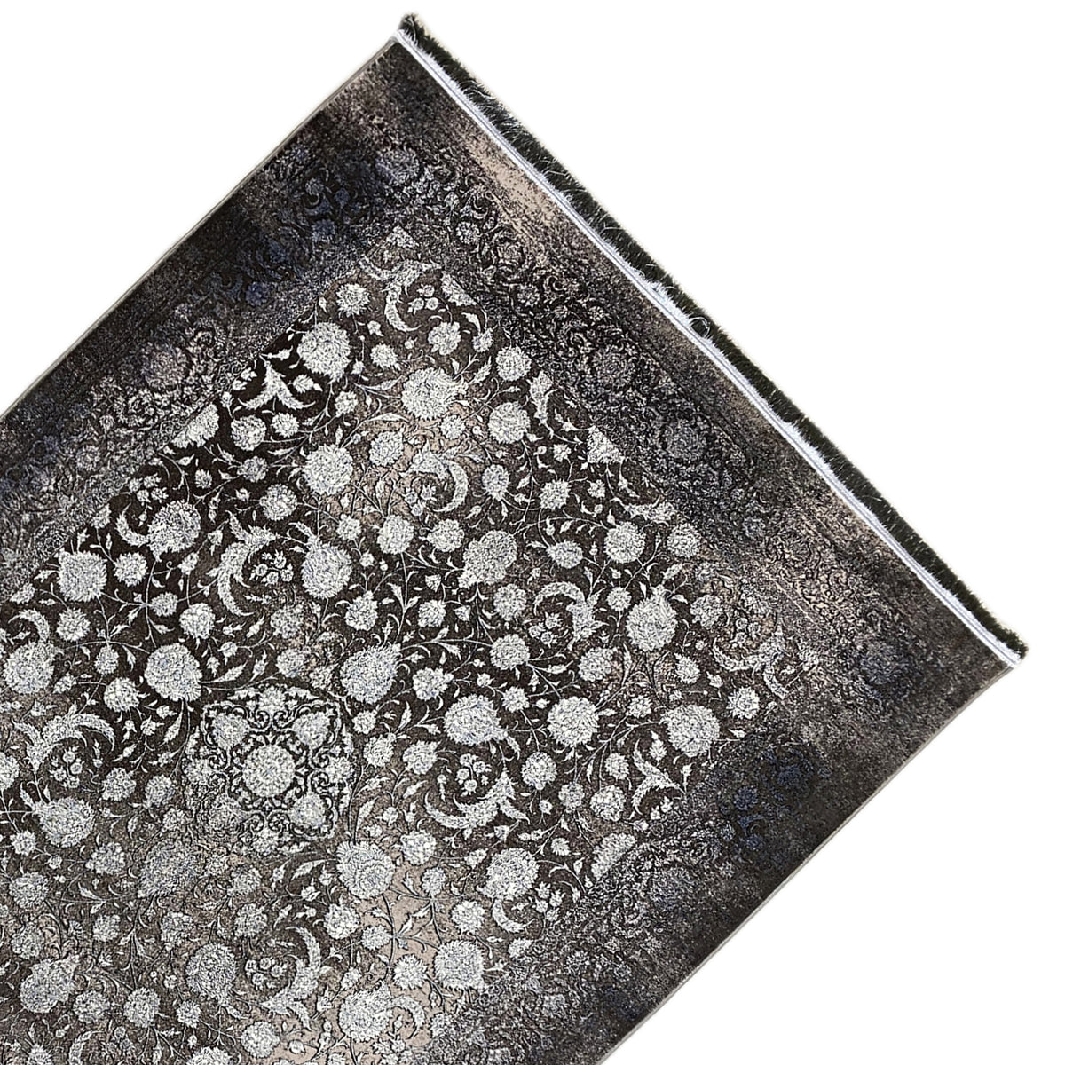 Moonflower rug 170x240 cm viewed at an angle, floral all-over pattern in gray/cream, fringes