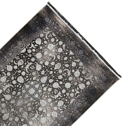 Moonflower rug 170x240 cm viewed at an angle, floral all-over pattern in gray/cream, fringes