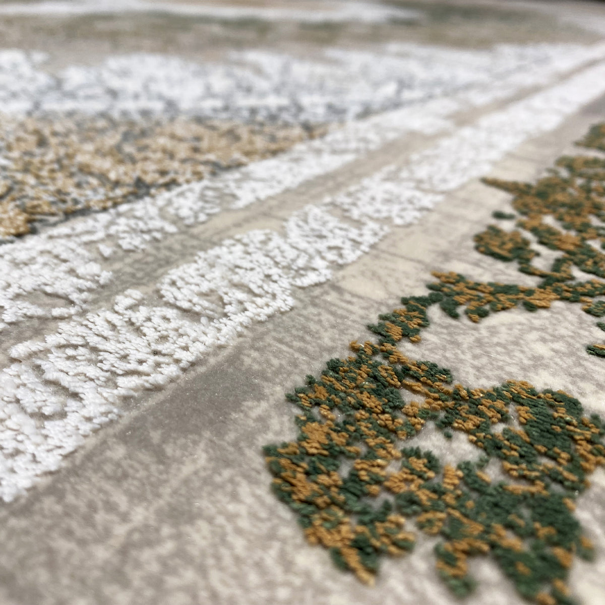 Rectangular rug with silver-gray pile and muted green ornamental accents