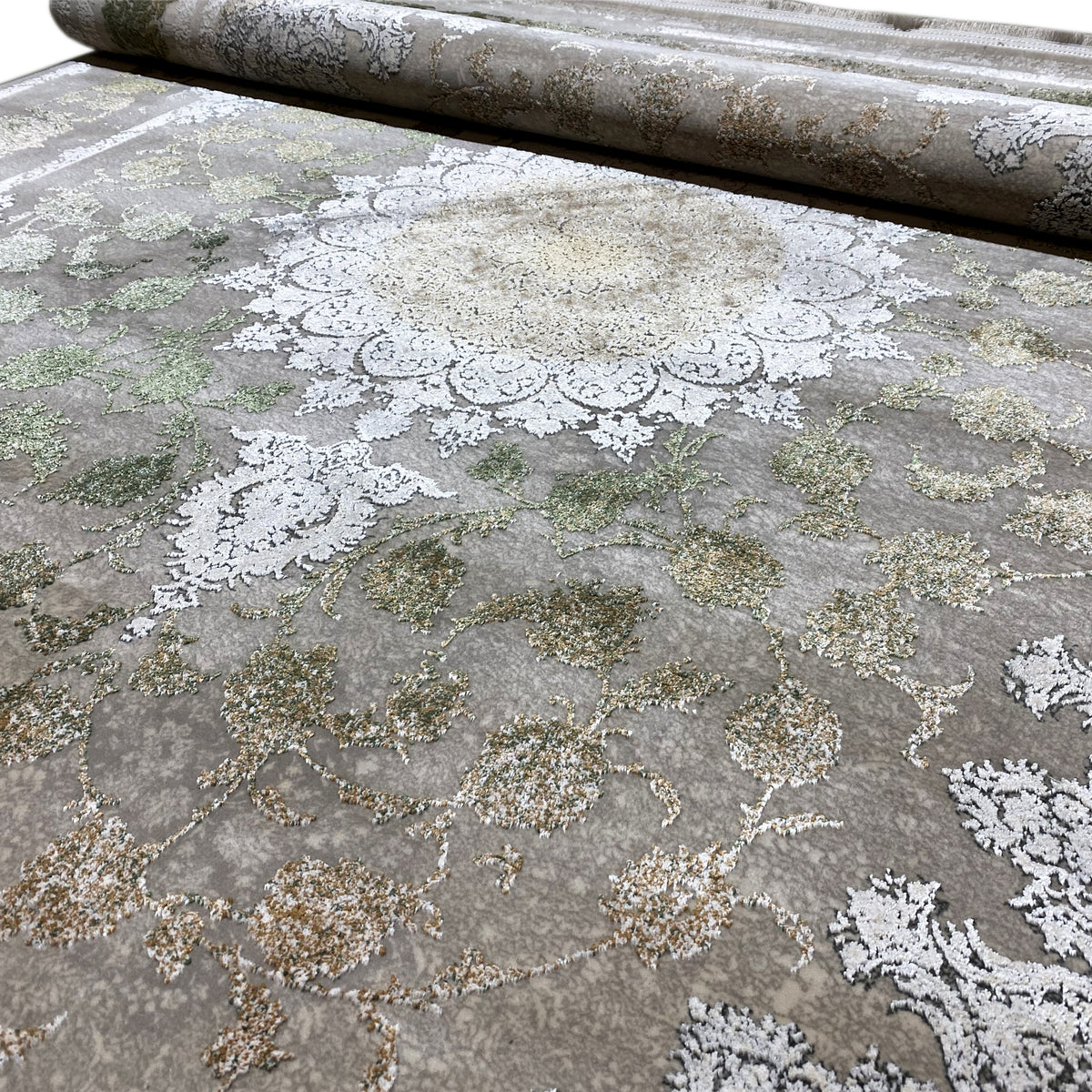 Rectangular rug with a detailed ornamental pattern in silver, cream, and green