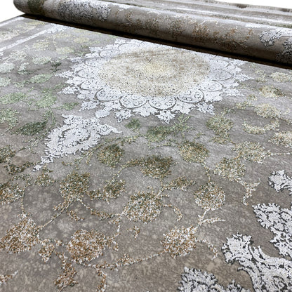 Rectangular rug with a detailed ornamental pattern in silver, cream, and green
