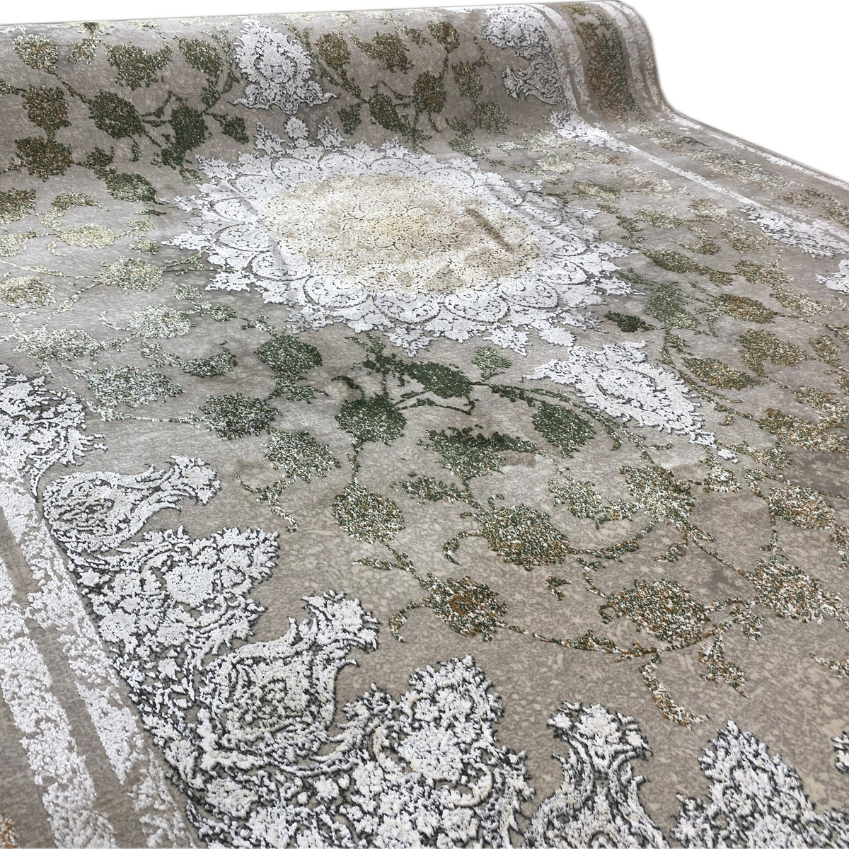 Rectangular rug with floral motifs in green, gold tones, and silver highlights