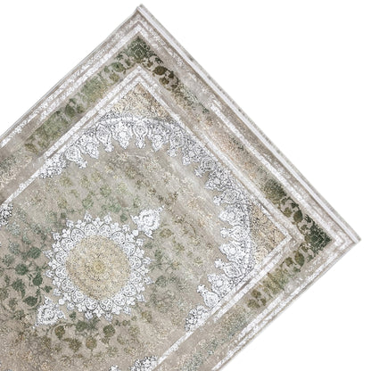 Rug 170x240 cm, diagonal view: silver ornamental band and green patterned areas