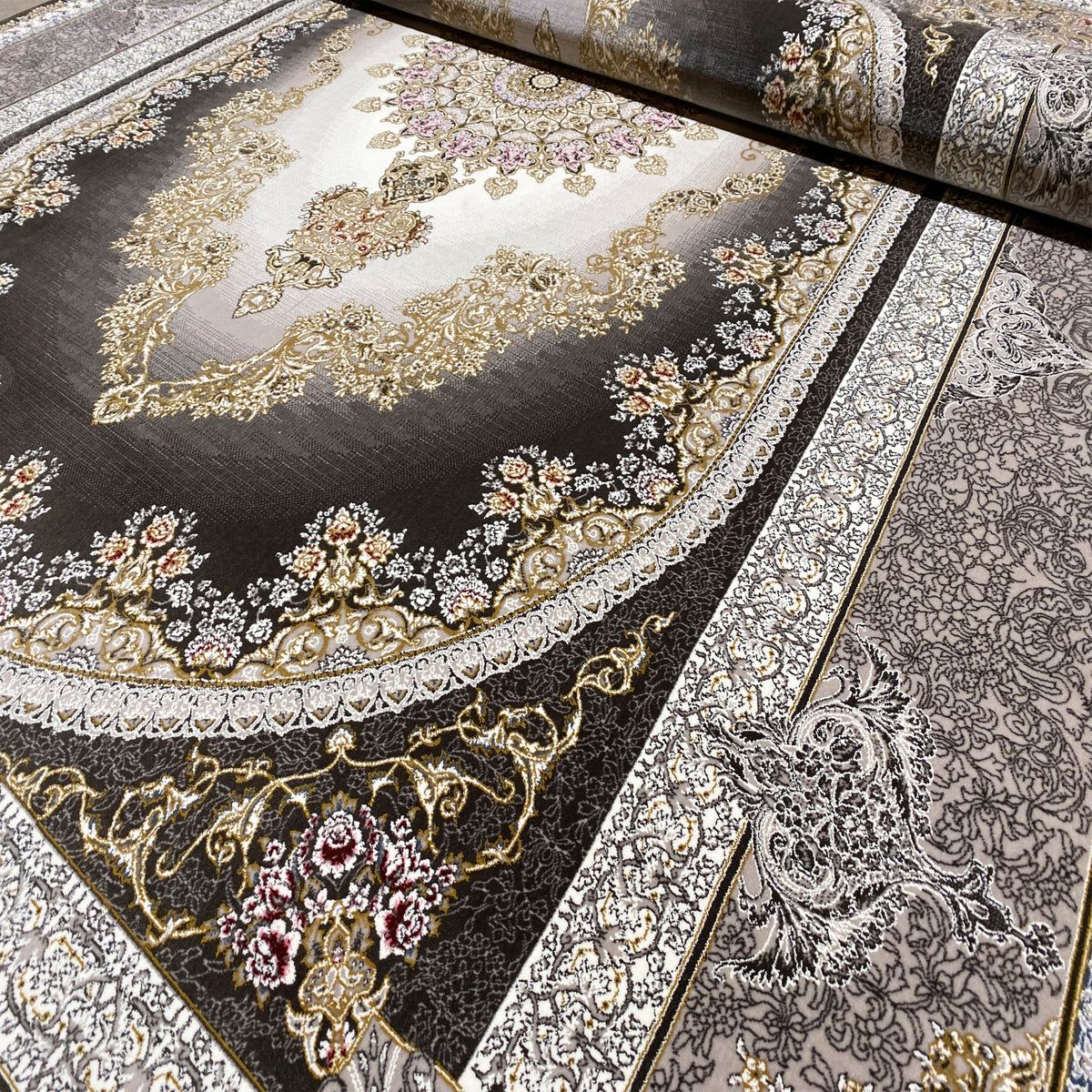 Smoke-gray rug with a round medallion, floral details, and silver borders