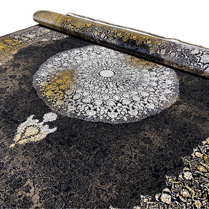 Close-up of an Oriental rug: silver medallion with golden-yellow highlights and black pile texture