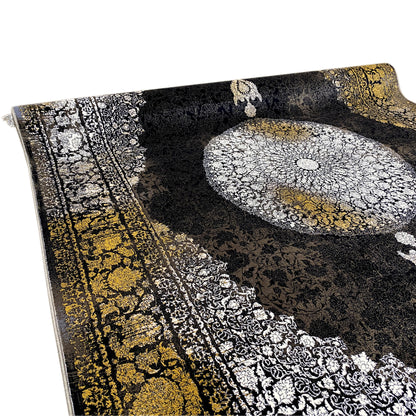 Rug with a black background, silver circular ornament at the top, golden border