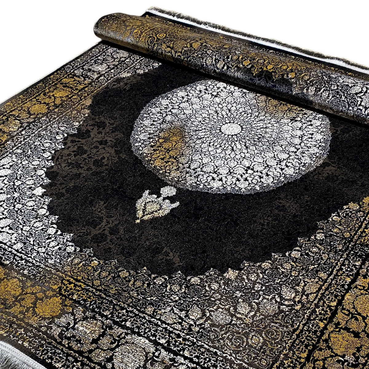 Close-up of an Oriental rug: large silver medallion, black field, gold-colored borders