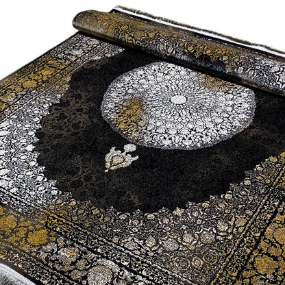 Close-up of an Oriental rug: large silver medallion, black field, gold-colored borders
