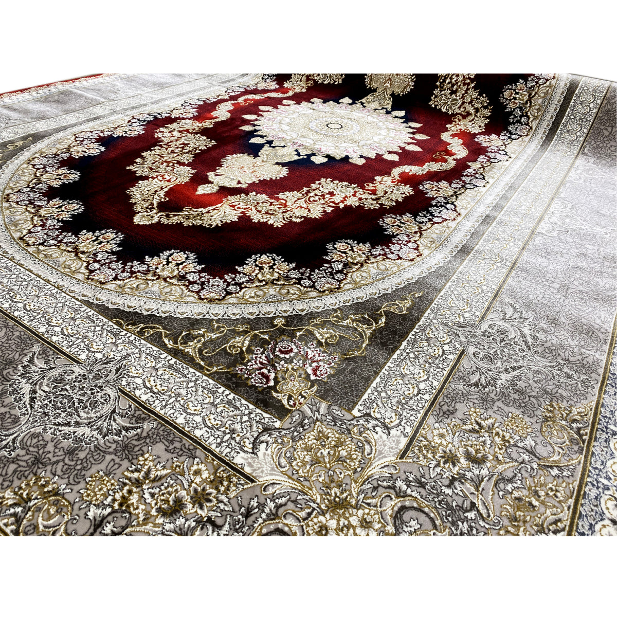 Close-up of an Oriental rug with a red center, gold embellishments, and a silver-gray pattern