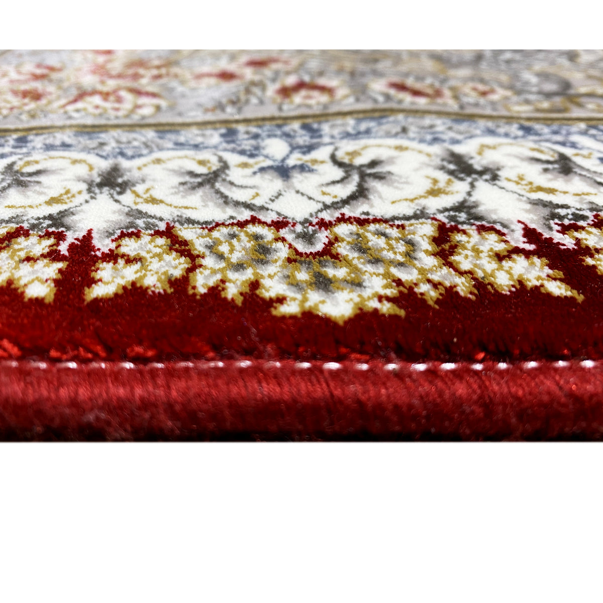 Carpet detail: pile and edge with a red-and-silver pattern.