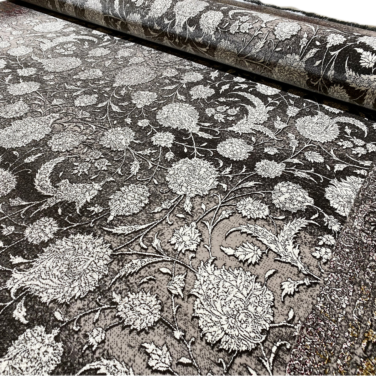 Velour rug with floral ornaments in silver on a dark background