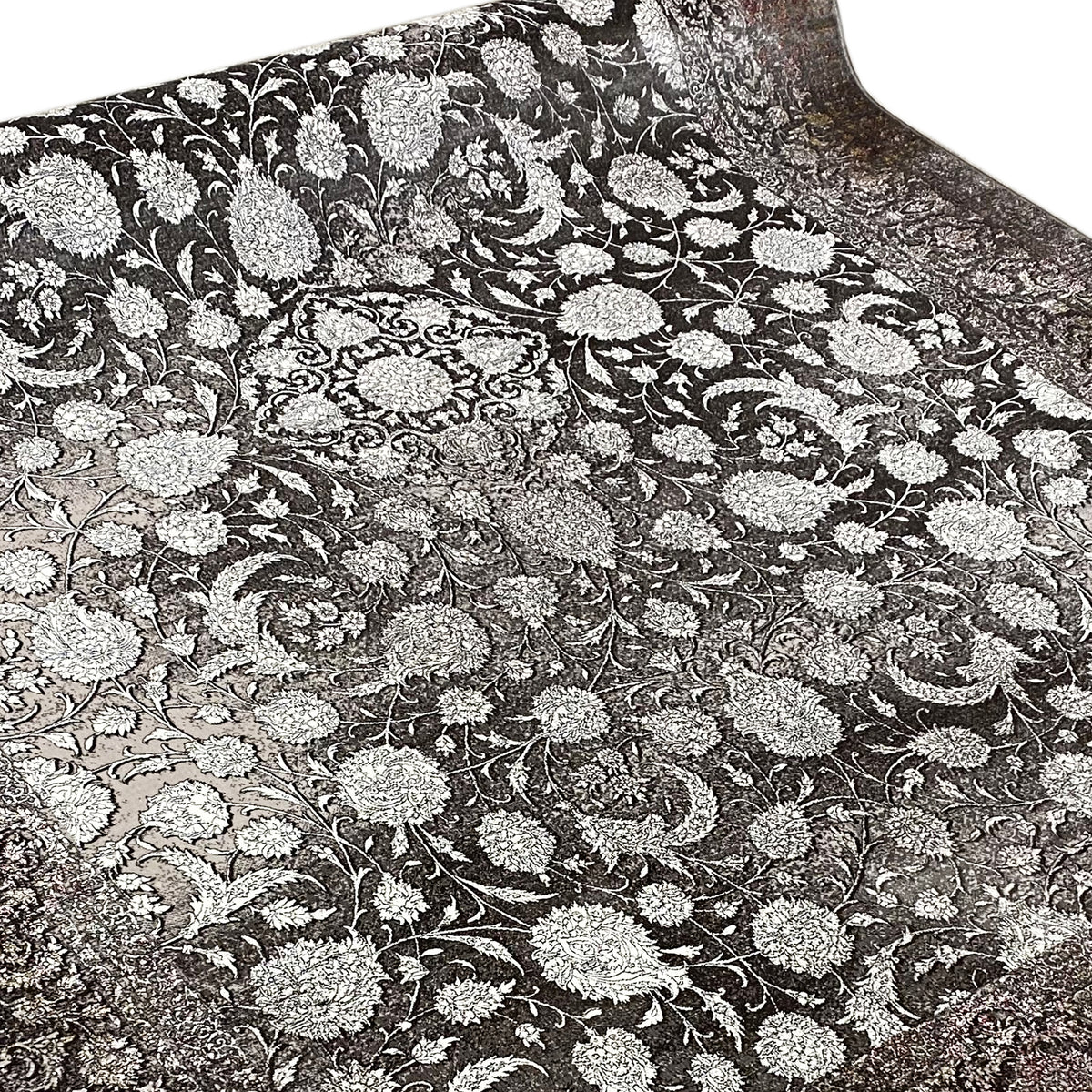 Velour rug with a dense floral ornamental pattern in silver on a dark background