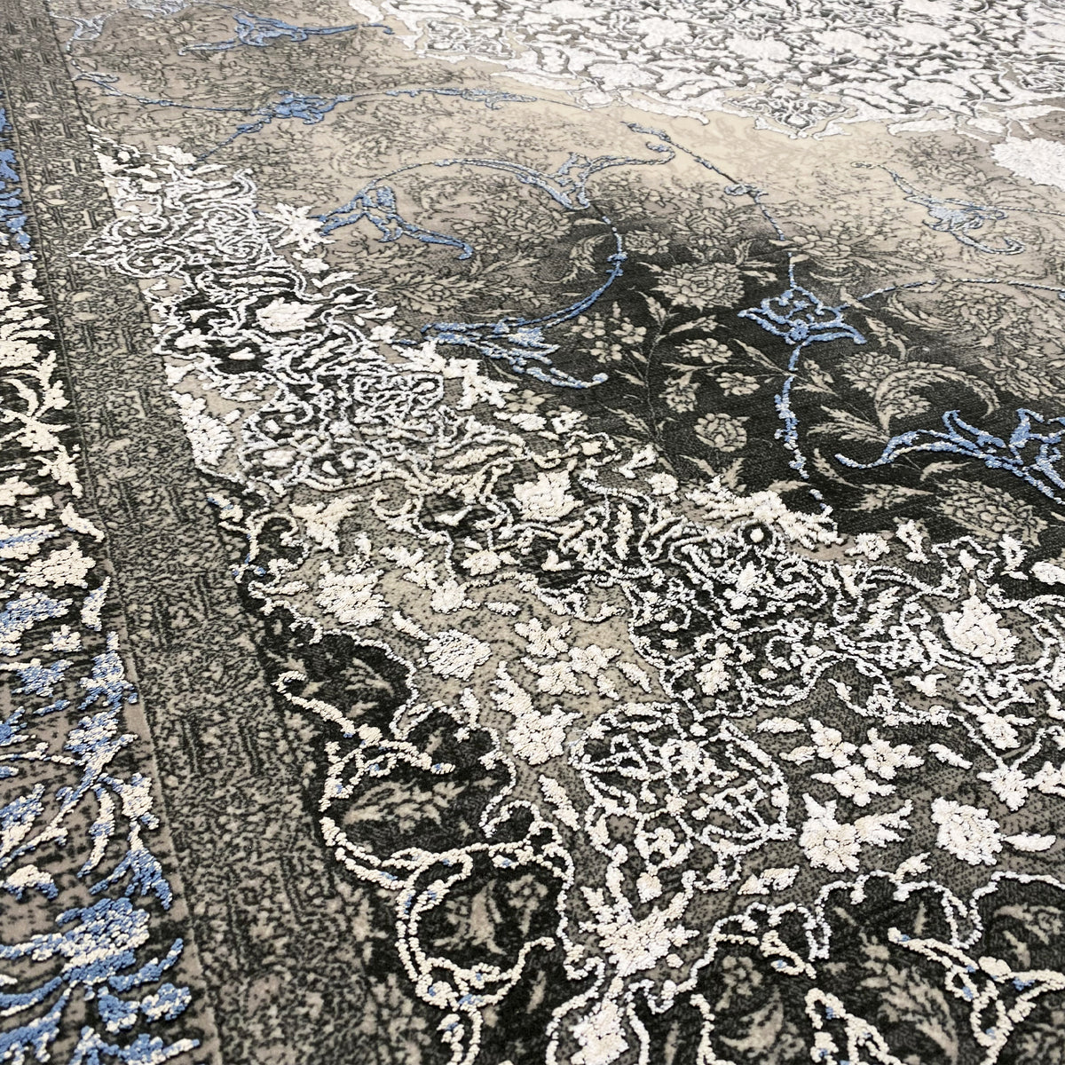 Rug 170x240 cm Detail: dark floral ornaments in silver, with a blue border