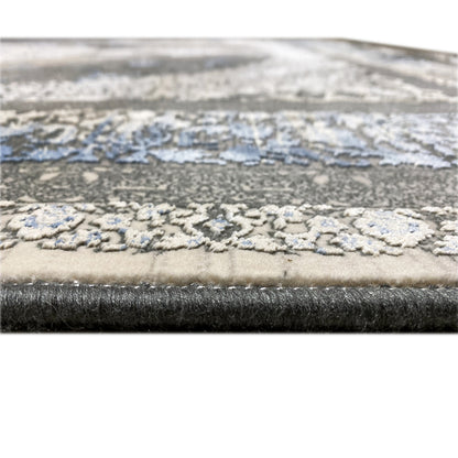 Carpet 170x240 cm close-up of the edge with a blue decorative gradient and textured pile surface