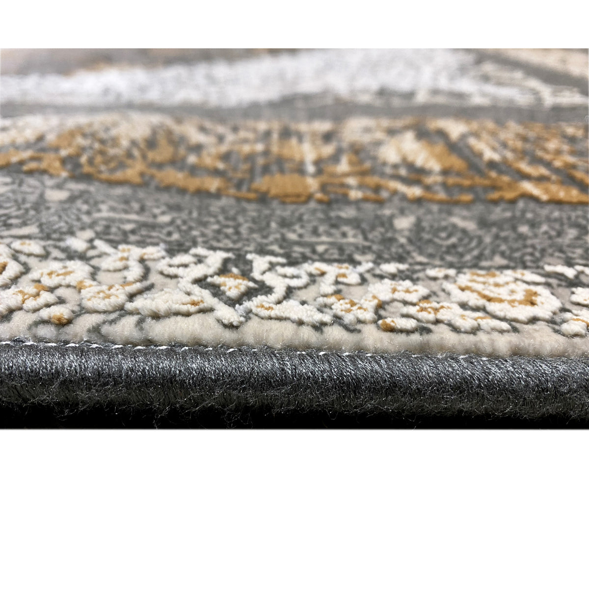 Close-up of the carpet edge: dense pile with a bound, patterned border