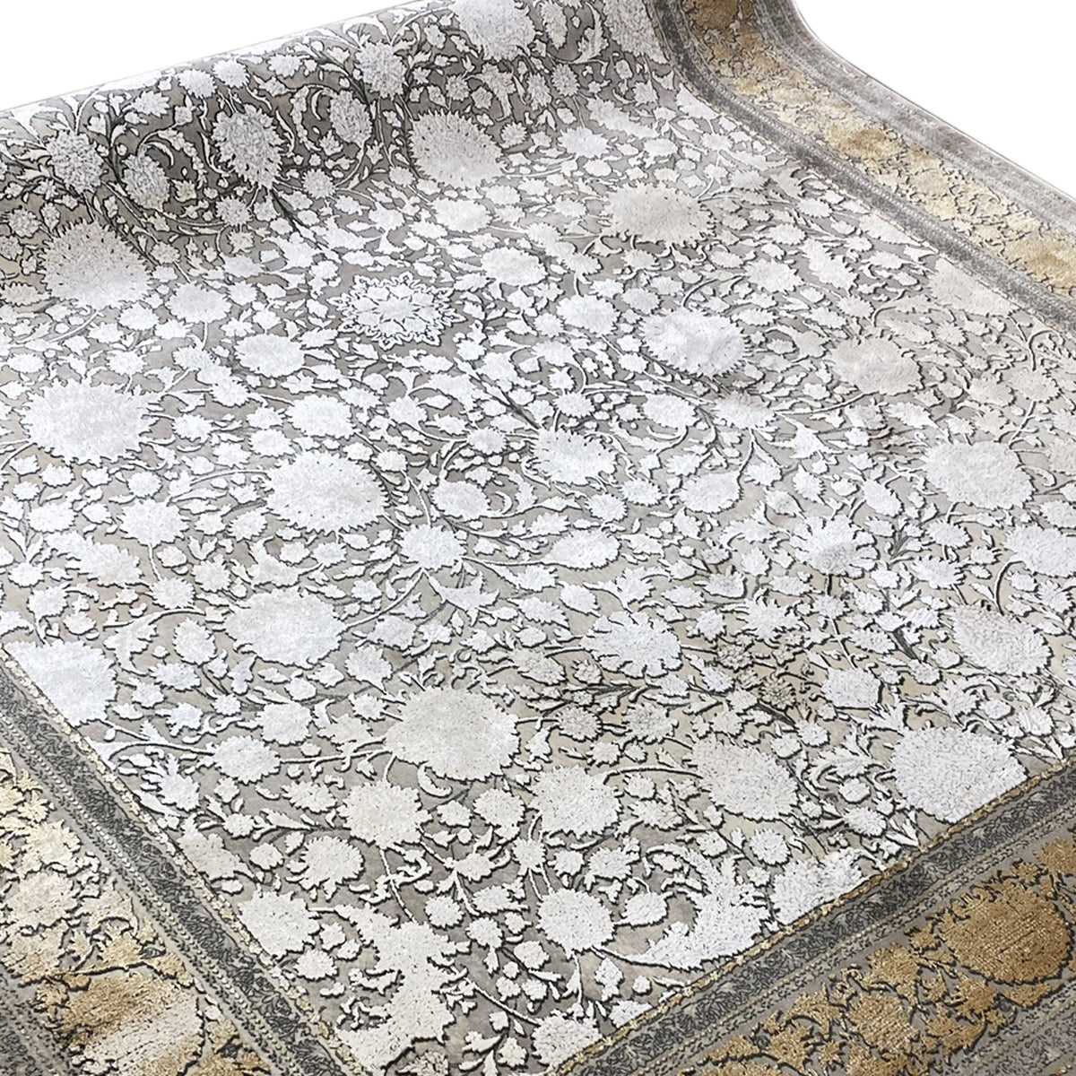 Silver-gray rug with floral ornaments and a gold-accented border