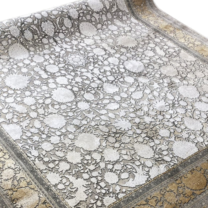 Silver-gray rug with floral ornaments and a gold-accented border