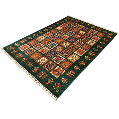 Green Khorjin rug with an overall square pattern, colorful motifs, and a border around the edges