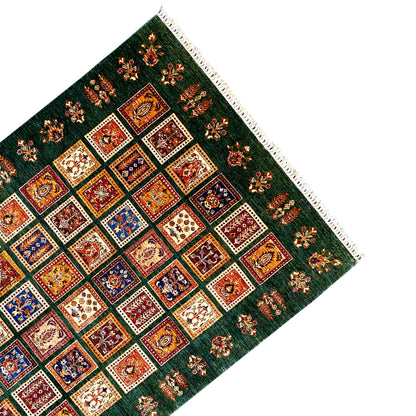 Khorjin rug corner with a dense pattern and fringed trim along the edge
