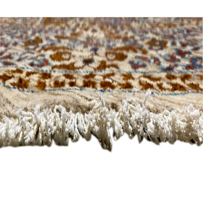 Rug edge with a high pile and tassels, beige and white, blue/brown patterned stripe