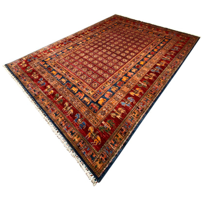 Reddish-brown rug with an ornamental grid, border, and short fringe along the edge