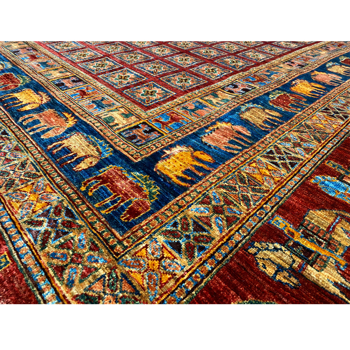 Detail view: Red, blue and yellow on an Oriental rug with a richly embroidered pattern