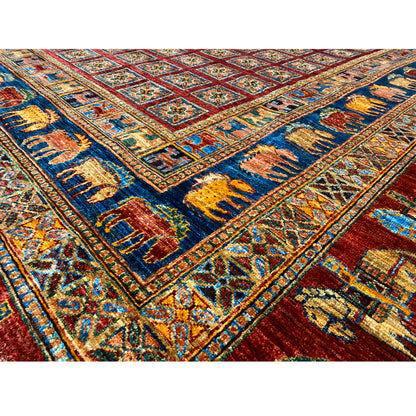 Detail view: Red, blue and yellow on an Oriental rug with a richly embroidered pattern