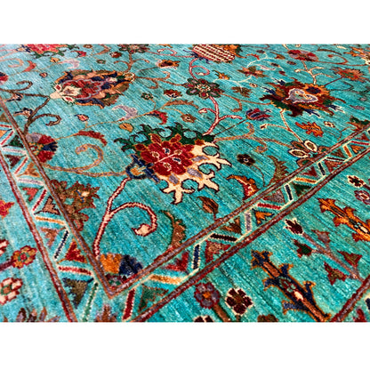 Detail view of the turquoise Khorjin rug: floral pattern with colorful flowers