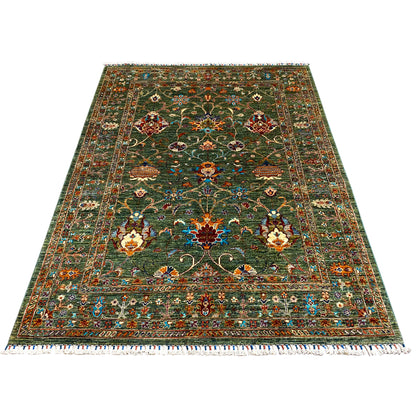 Khorjin rug in dark green, large central field with floral patterns