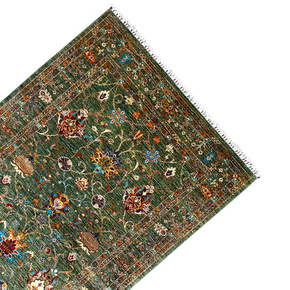 Khorjin rug in dark green, angled, with a surrounding frame and decorative border