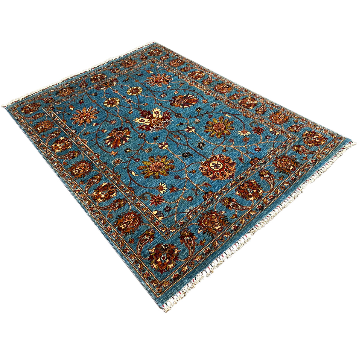 Blue Khorjin rug in a diagonal view, floral pattern and decorative lines, with fringes