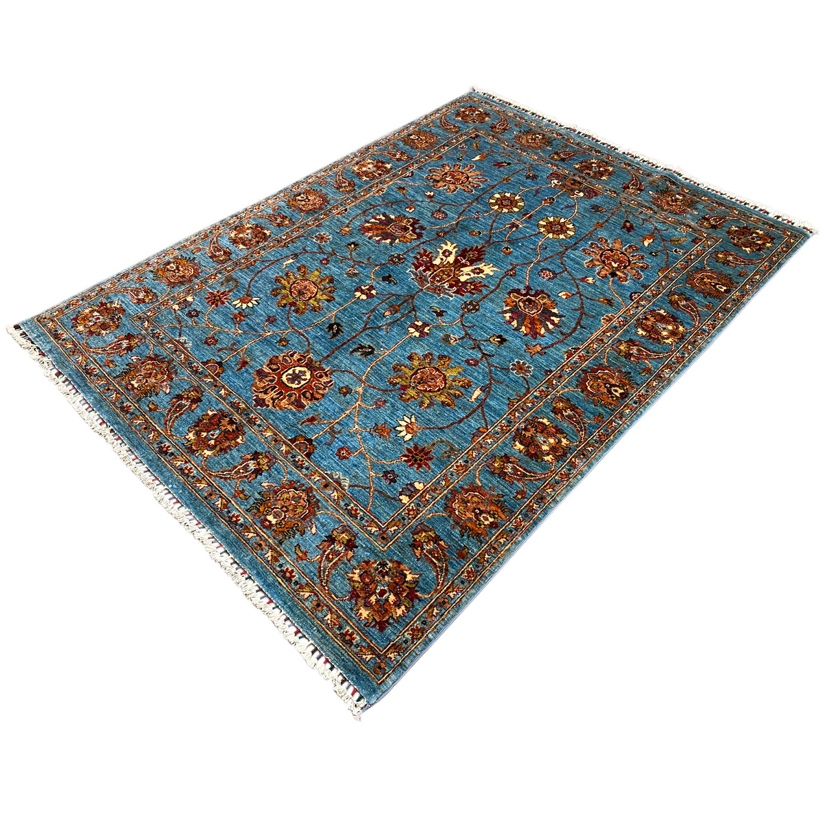 Blue Khorjin rug with a central medallion, floral ornaments, fringes along the edge