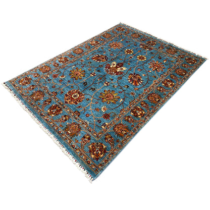 Blue Khorjin rug with a central medallion, floral ornaments, fringes along the edge