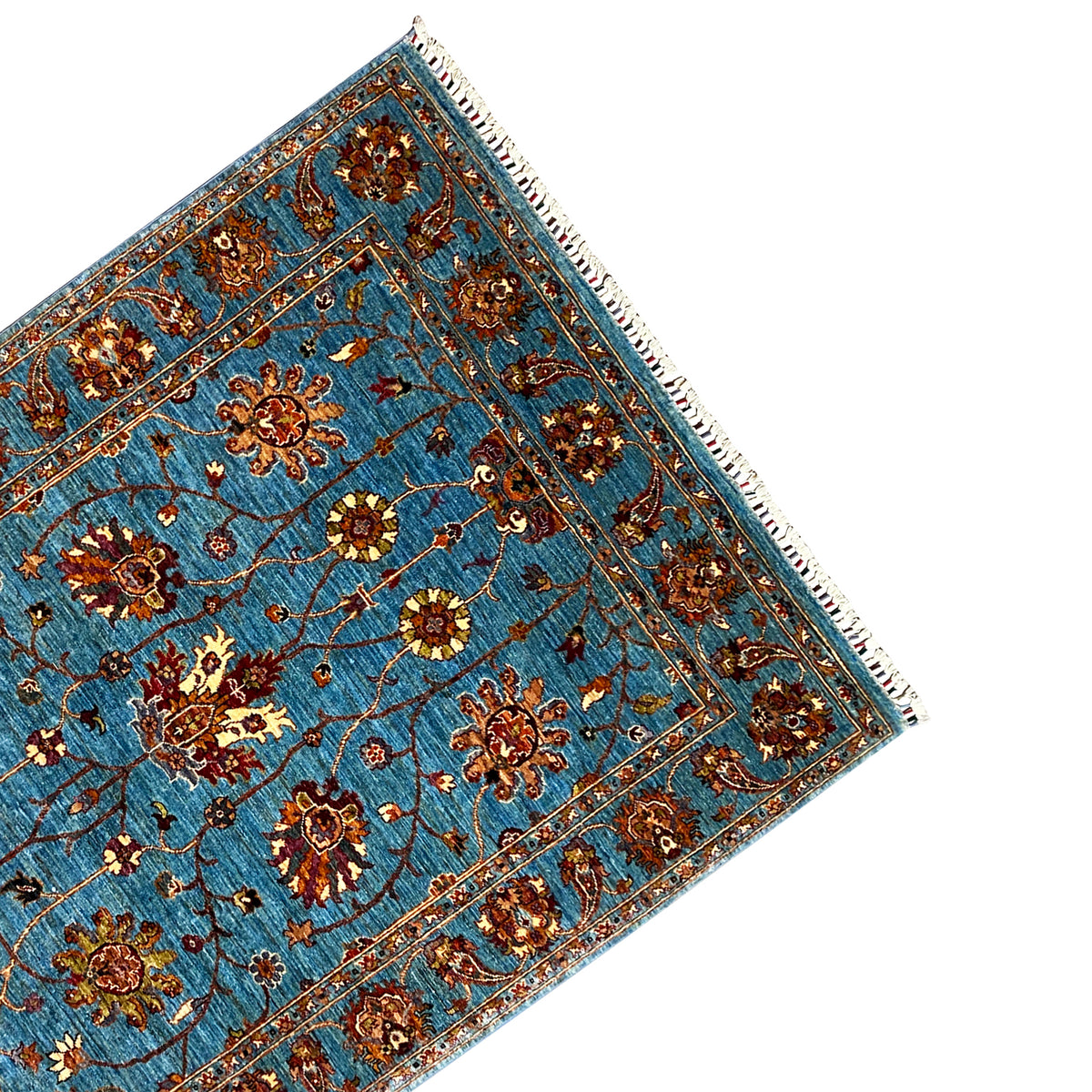 Blue Khorjin rug corner with ornamental border, floral motifs and fringes