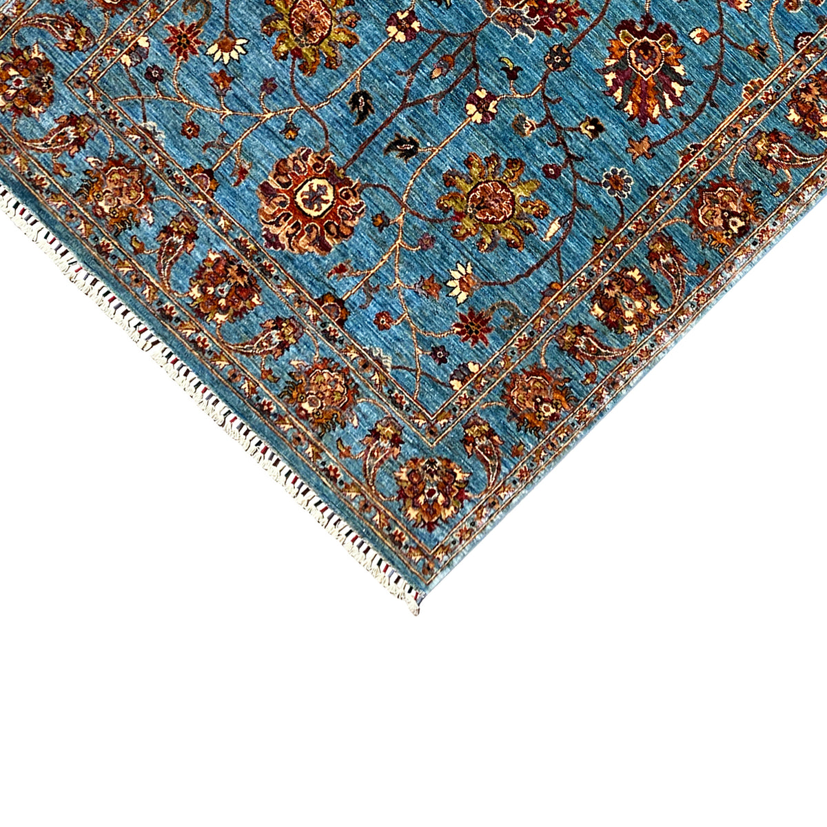 Blue Khorjin rug corner detail with medallion, decorative lines, and fringes