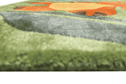 Close-up of the hand-tufted carpet edge: green pile with a colored border