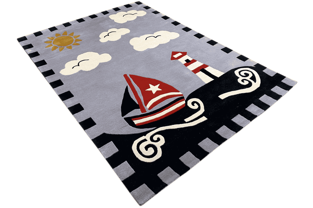 Children's sailing boat rug in an angled view: gray background with a sailboat, clouds, and border