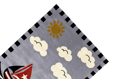 Children's sailing boat rug from above: gray background with sun, clouds, and diamond border