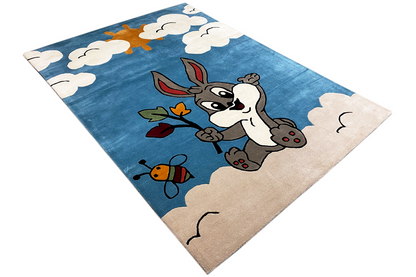 Children's rug with a diamond cutout: bunny, bee and leaves beneath clouds, blue