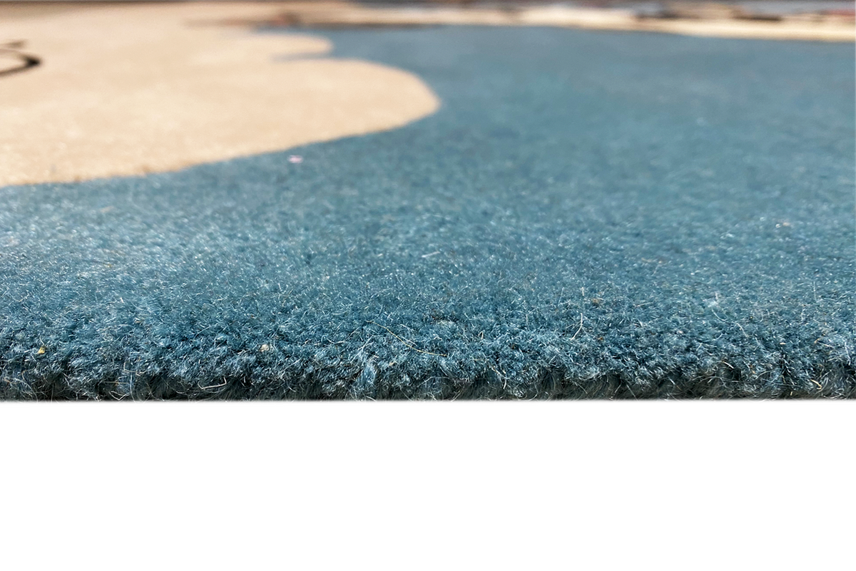 Close-up: blue carpet pile with a soft, dense texture