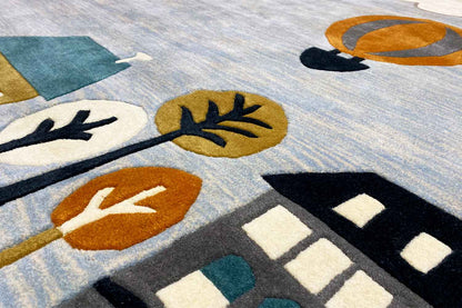 Hand-tufted wool rug, detailed view with houses, branches, and hot-air balloon.