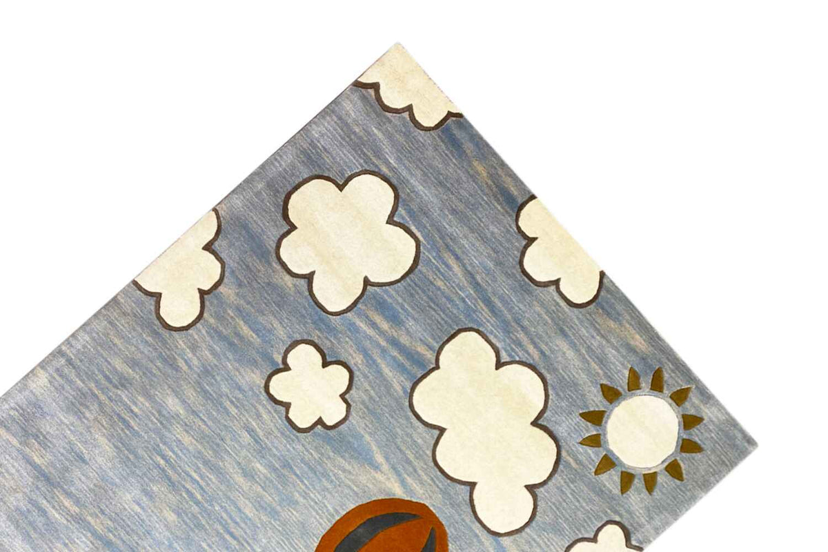 Hand-tufted wool rug with clouds and sun in the upper area.