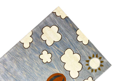 Hand-tufted wool rug with clouds and sun in the upper area.