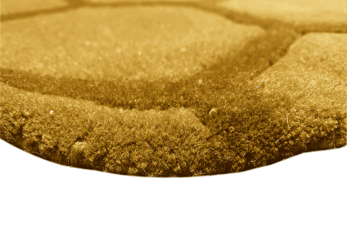 Round honeycomb rug, yellow-brown pile in detail, close-up of the selvedge