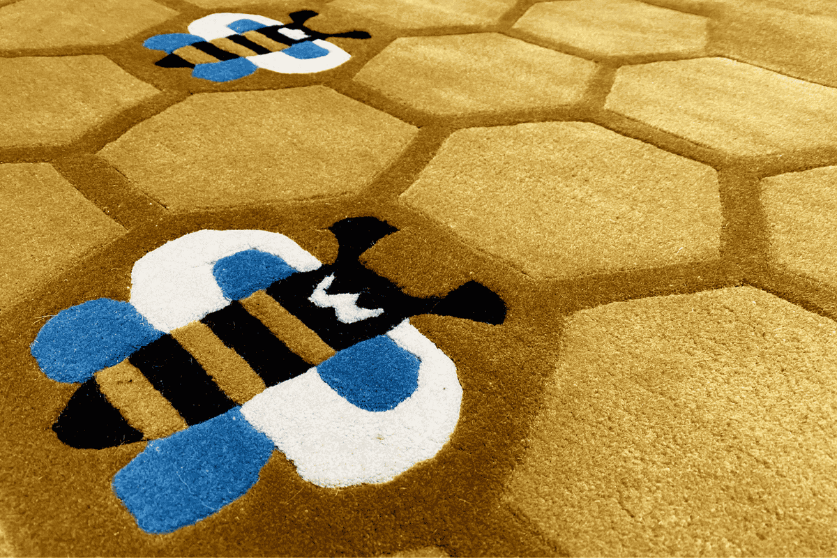 Round honeycomb rug for children, yellow-brown surface with bee embroidery