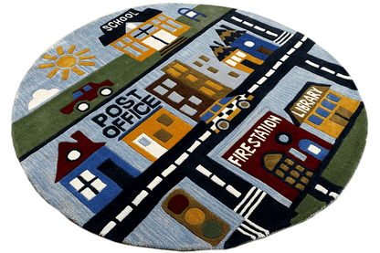 Round children's city rug with a hand-tufted pattern of streets, houses, and mountains