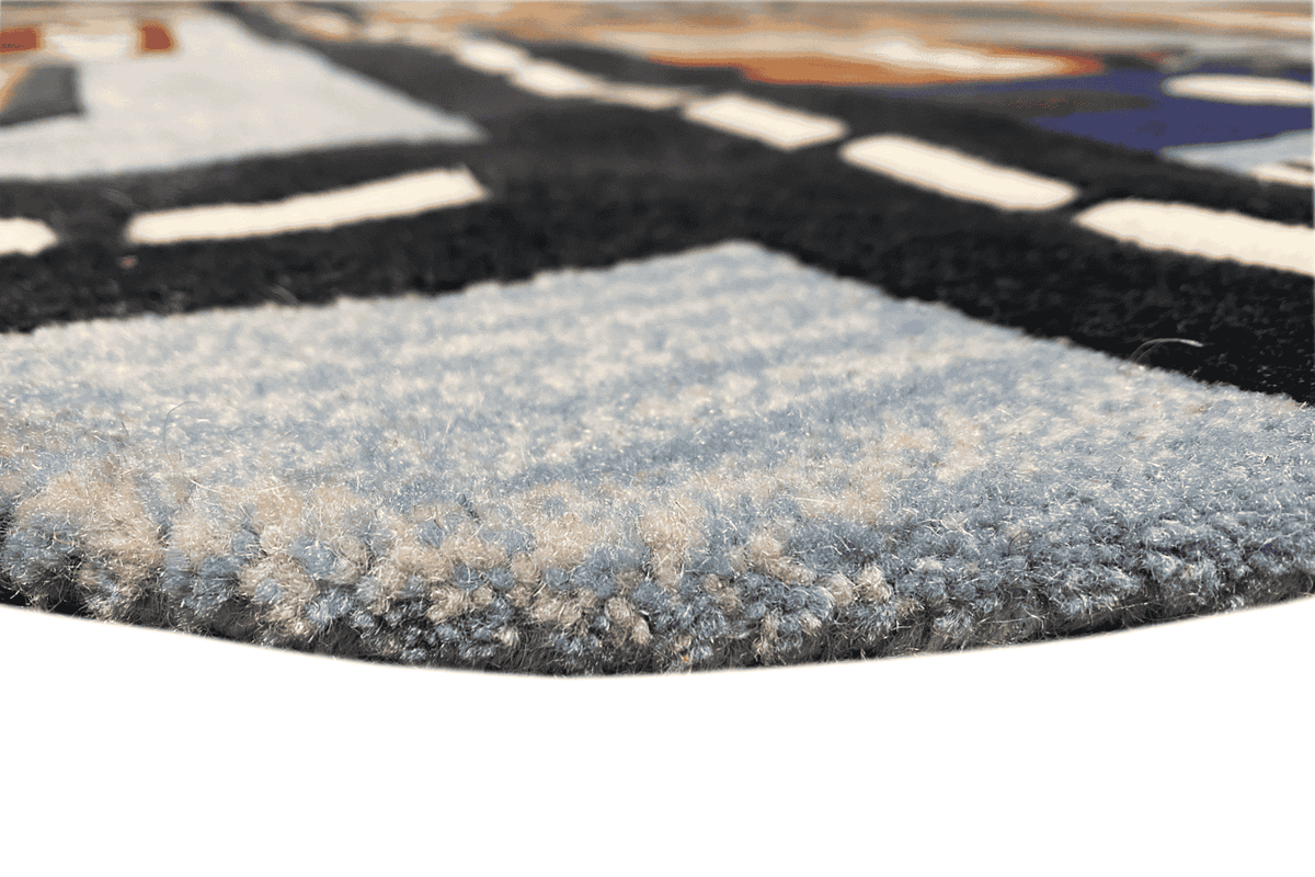 Close-up of the carpet pile: dense blue-gray loop pattern on a dark background