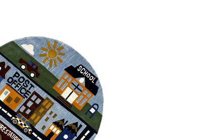 Corner of a round children's city play rug with a “School” building and yellow sun